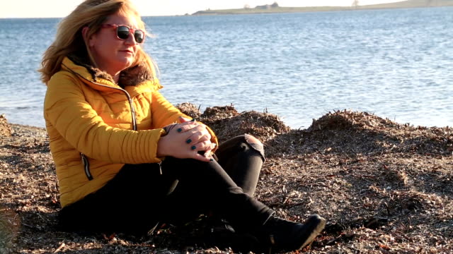 Sad-pensive-woman-on-winter-sea-beach