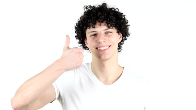 Thumbs-Up-von-Jüngling-mit-lockigen-Haaren,-weißer-Hintergrund