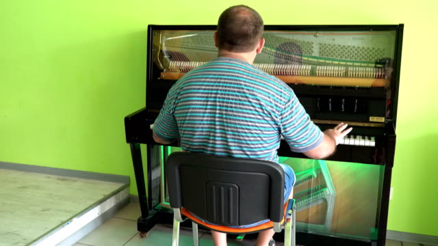 A-man-playing-on-a-transparent-piano