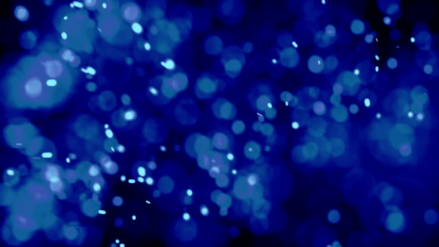 Blue-Colored-Cinematic-Looking-Particles-With-Turbulence-Motion-Moving-In-Front-Of-Camera-With-Shallow-Dof-On-Black-Background