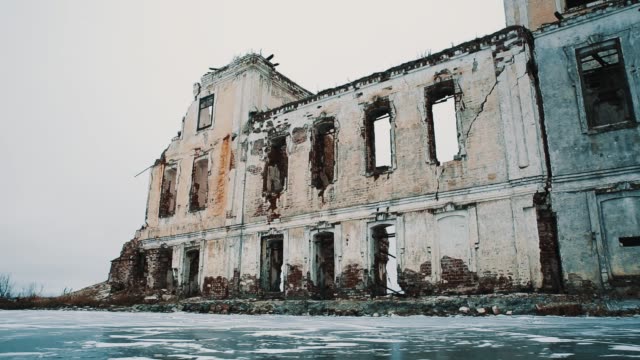 Destroyed-church-building-in-middle-of-frozen-lake-covered-in-snow