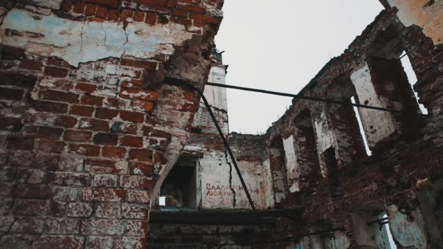 Inside-destroyed-orthodxal-church-red-bricks-walls,-cold-cloudy-day