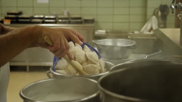 Cafeteria-Cook-Pours-Pierogies-in-Boiling-Pot