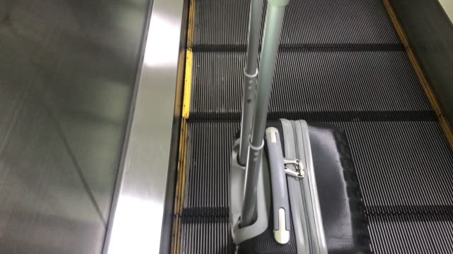 Travel-bag-on-travelator-or-slide-way-in-airplane