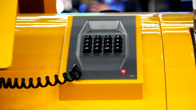 the-person's-hand-lifts-the-telephone-receiver,-built-into-the-table
