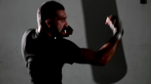 Male-bearded-boxer-exercising-shadow-boxing.