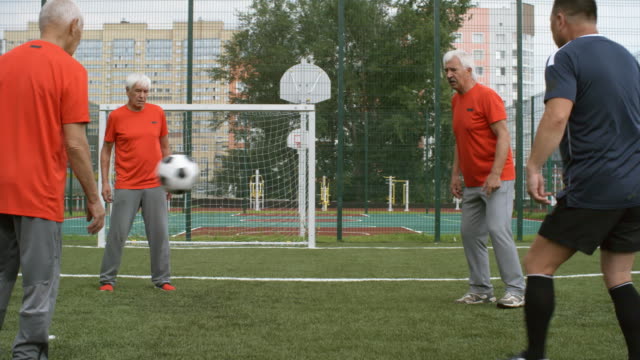 Group-of-Seniors-Training-with-Football-Outdoors