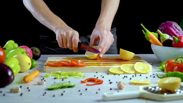 Man-is-cutting-lemon-in-the-kitchen