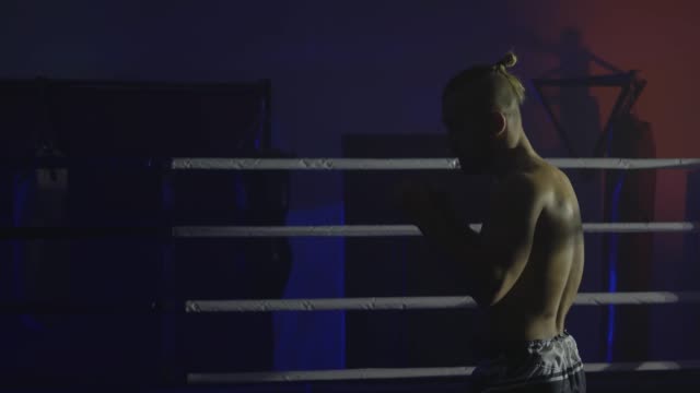 sports-boxer-trains-punches-in-ring-in-twilight-before-sparring-on-competition