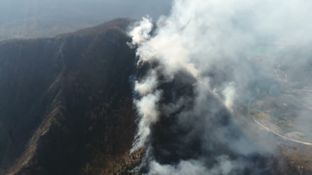 Aerial-footage-of-a-mountain-covered-in-thick-smoke