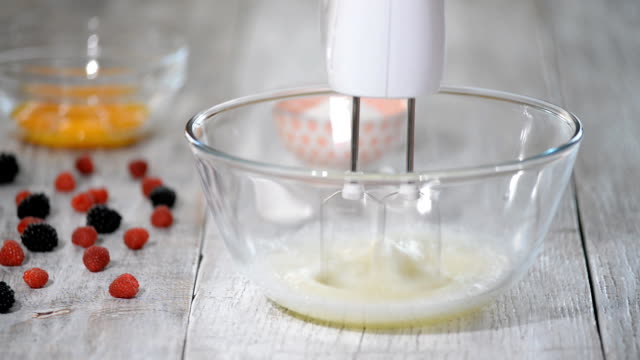 Kitchen-mixer-beating-the-eggs-white-egg-whites-into-a-thick-foam.