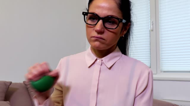 Depressed-woman-squeezing-stress-ball