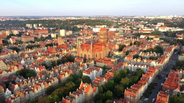 Gdansk-old-city-in-the-rays-of-the-rising-sun,-aerial-view-of-the-old-city-streets