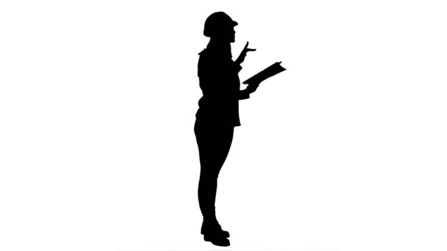 Silhouette-Young-engineer-woman-reading-technical-drawings-and-analyze-it