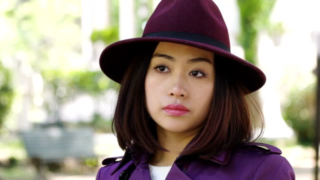 portrait-of-sad-thoughtful-30s-asian-woman-in-the-city