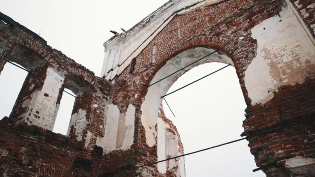 Inside-ruined-orthodxal-cathedral-red-bricks-walls,-cold-cloudy-day