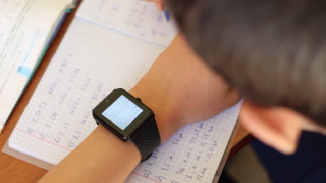 Learner-doing-homework-with-Smart-Watch-device