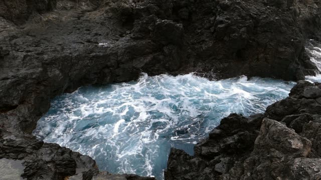 Big-waves-crashing-on-cliff-of-lava-rocks.Slow-motion.