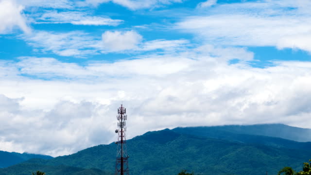 Time-Lapse-Phone-Tower-background-is-clouds,-rain-and-mountains.