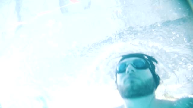 Disabled-man-swims-in-a-swimming-pool.-Underwater-shot.-Slow-motion