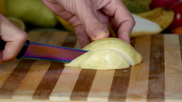 Man-is-slicing-pear-in-slow-motion
