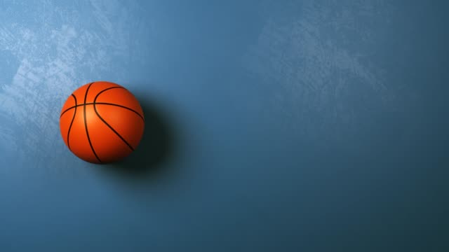 Basketball-Ball-Rotating-on-Blue-Background-with-Copyspace