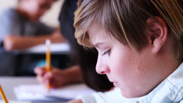 Elementary-school-boy-concentrating-during-a-test,-close-up