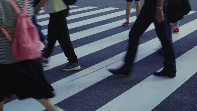 Close-up-shot-of-a-busy-pedestrian-street-crossing-in-Japan-on-a-hot-summer-day.