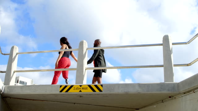 Couple-walking-with-hand-in-hand-near-railing-4k