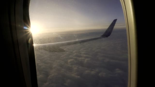 Sonnenuntergang-am-Himmel-aus-dem-Flugzeug-Fensterflügel-des-Flugzeugs.