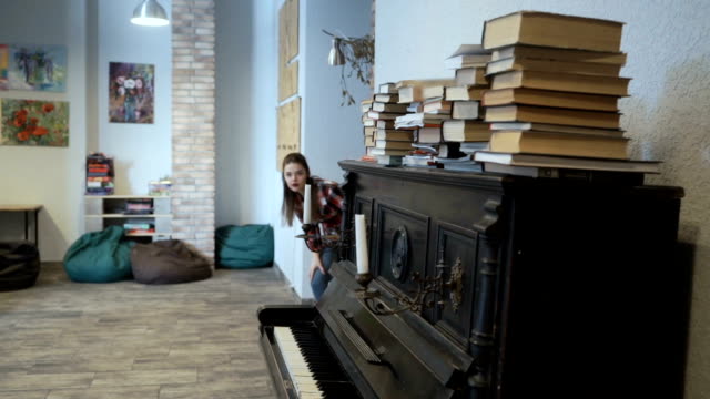 Young-girl-furtively-touches-piano-key