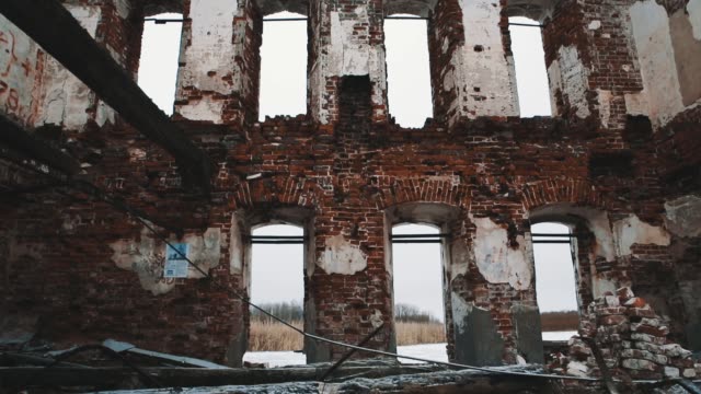 Inside-destroyed-orthodxal-cathedral,-red-bricks-walls,-cold-cloudy-day