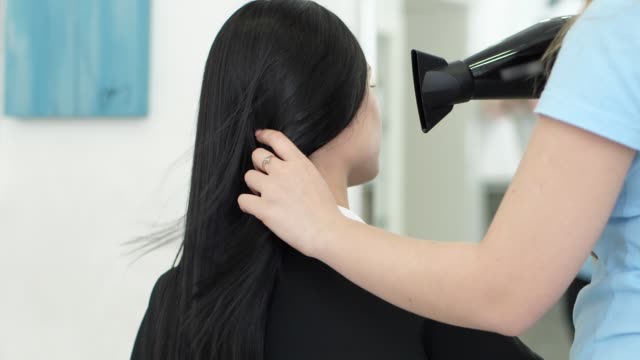 hair-drying,-brunette-visited-hairdresser-in-beauty-salon-for-hair-care