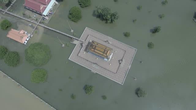 Locked-overhead-drone-shot-of-a-pagoda-is-surrounded-by-floodwaters