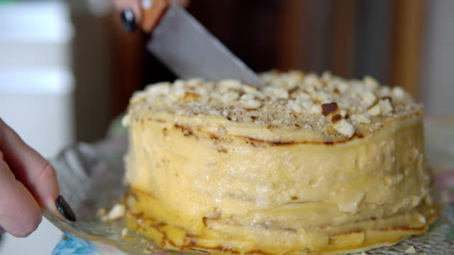 Close-up-of-cutting-a-cake-with-a-large-knife
