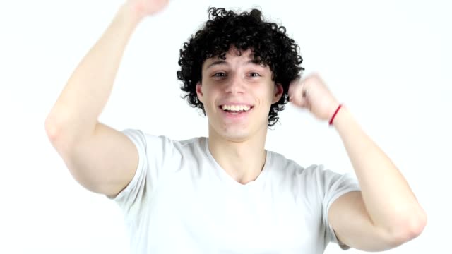 Excited-Young-Man-with-Curly-Hairs-Celebrating-Success