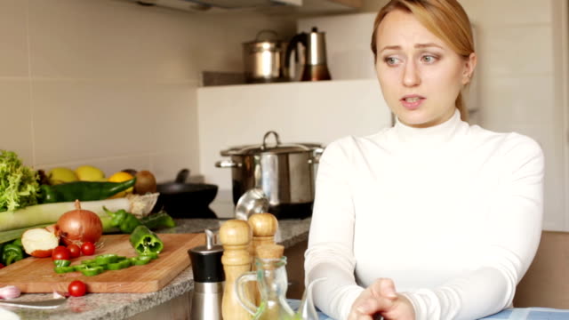 Stressed-woman-sitting-at-kitchen