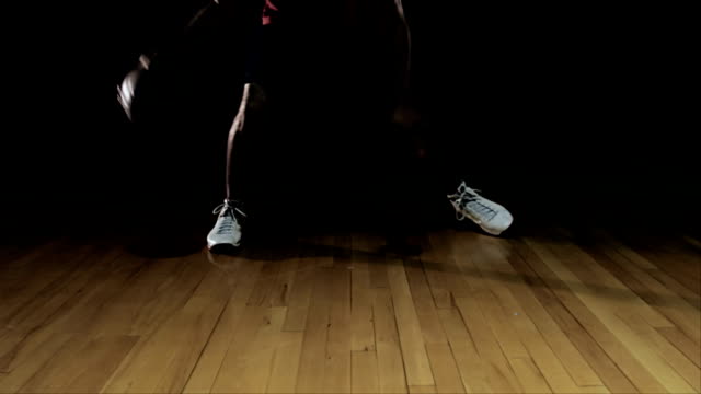 A-basketball-player-making-dribbling-moves-and-practicing-on-court.