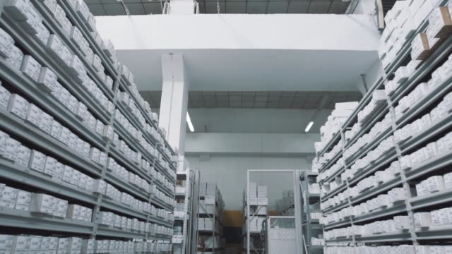 Bright-repository-shelves-full-of-white-boxes-with-numbers-markings