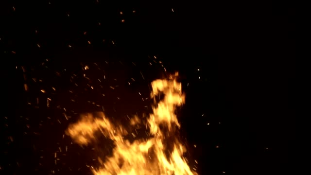 Burning-ash-rise-from-large-fire-in-black-background