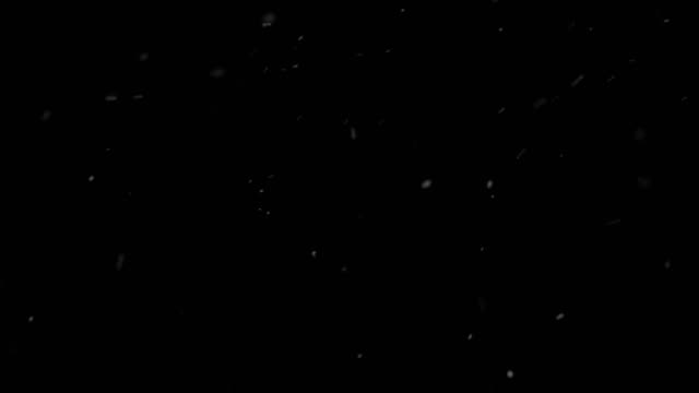 Heavy-snow-falling-on-black-background-looped-for-overlay