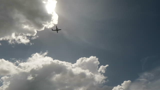 Passenger-plane-taking-off-overhead-through-blue-sky