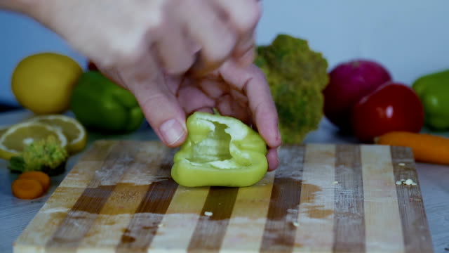 Chef-is-cutting-vegetables-in-the-kitchen,-slicing-sweet-pepper