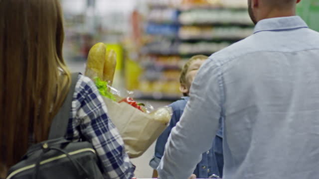 Rear-View-of-Family-Going-through-Supermarket