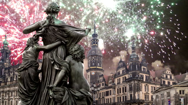 Sculpture-on-the-Bruhl-Terrace-and--Hofkirche-or-Cathedral-of-Holy-Trinity-and-holiday-fireworks---baroque-church-in-Dresden,-Sachsen,-Germany