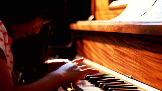 Schoolgirl-learning-piano-in-music-class-4k