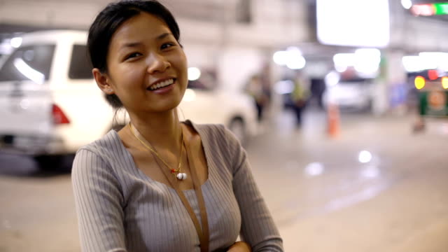 Smiling-Asian-woman-in-underground-car-parking
