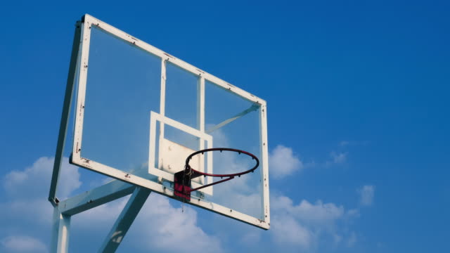 Basketball-cage-against-blue-sky-on-sunny-summer-day