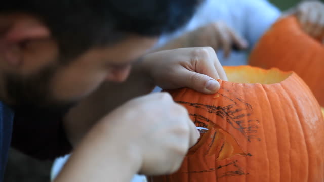 Carving-Halloween-pumpkins-outside