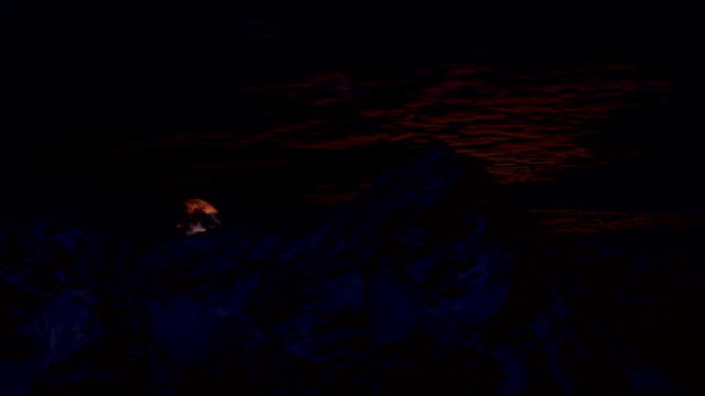 Full-moon-rising-at-night-behind-the-mountains